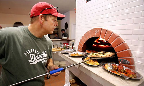 John Durning making pizza